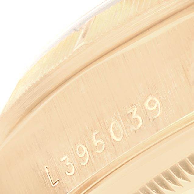 This close-up image of a Rolex President 18248 Men
s Yellow Gold Champagne Dial 18248 Men
s Yellow Gold Champagne Dial model watch shows the engraved serial number on the casing.