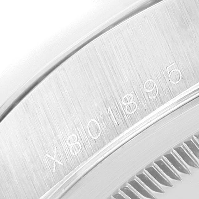 The image shows a close-up of the Rolex President 18346 Men's Platinum Silver Dial 18346 Men's Platinum Silver Dial model watch's serial number engraved on the case back.