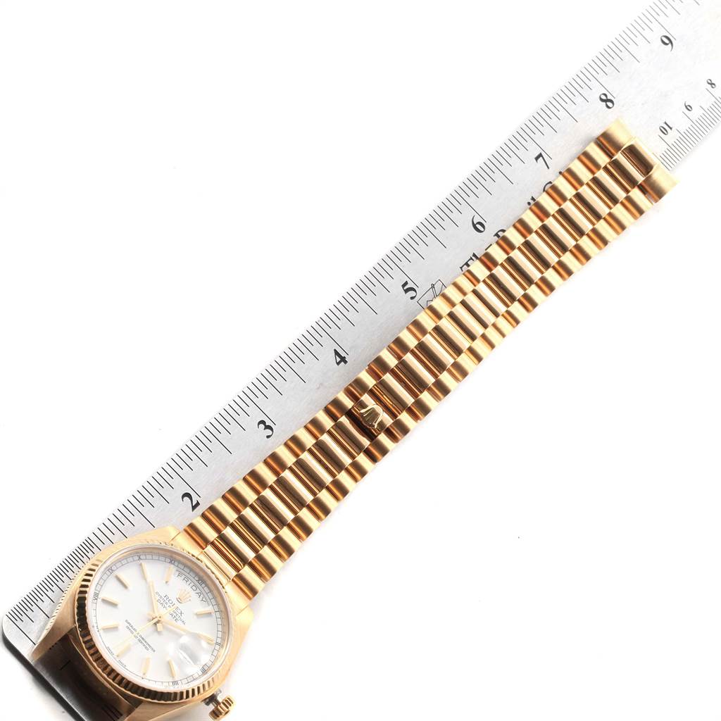 The image shows a Rolex President 18038 Men
s Yellow Gold White Dial 18038 Men
s Yellow Gold White Dial model watch laid flat with a ruler measuring its bracelet length.