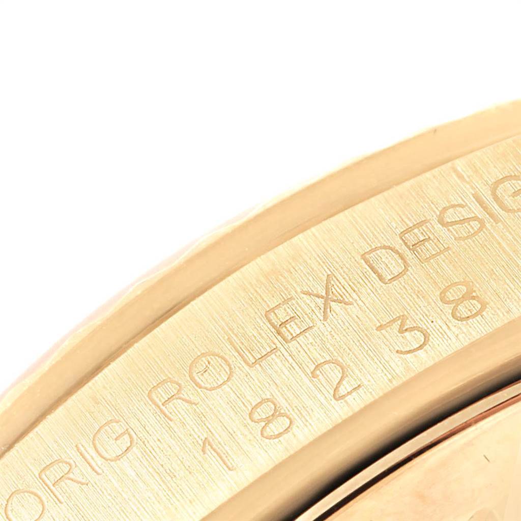 This close-up image shows the embossed text and part of the bezel of a Rolex President 18238 Men
s Yellow Gold Champagne Dial 18238 Men
s Yellow Gold Champagne Dial model watch.