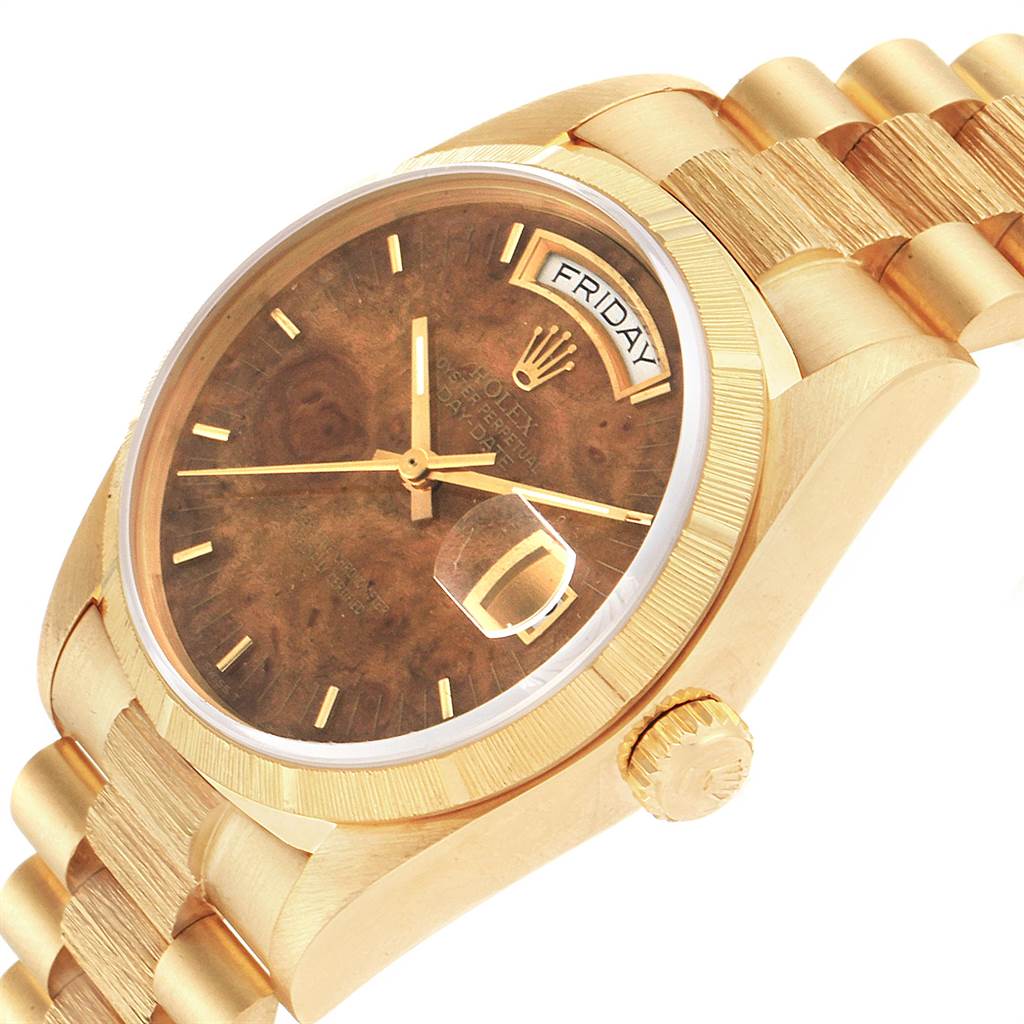 This image shows a close-up of the Rolex President 18078 Men
s Yellow Gold Brown Dial 18078 Men
s Yellow Gold Brown Dial model watch, featuring its dial, day-date display, crown, and part of the bracelet.