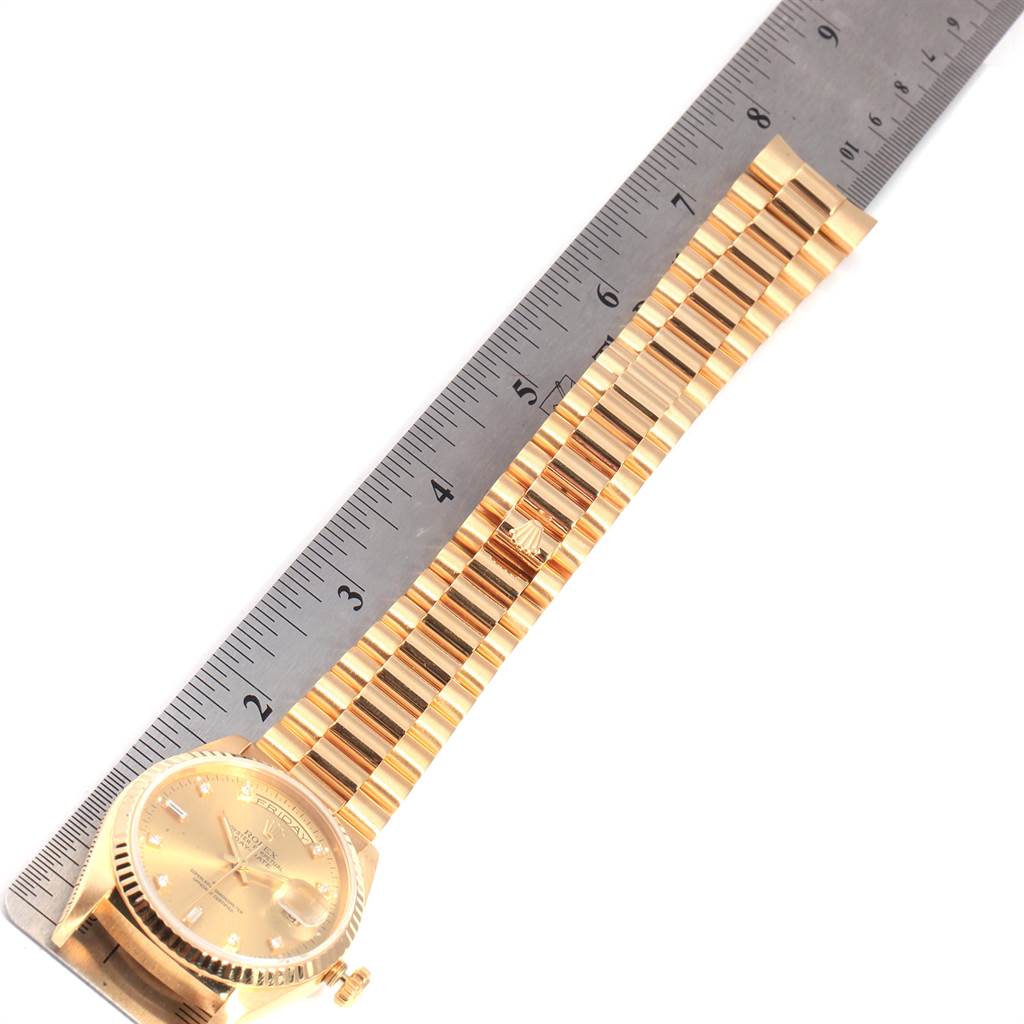 The image shows a Rolex President 18238 Men
s Yellow Gold Champagne Dial 18238 Men
s Yellow Gold Champagne Dial model watch laid flat with the band and case visible, next to a ruler for scale.