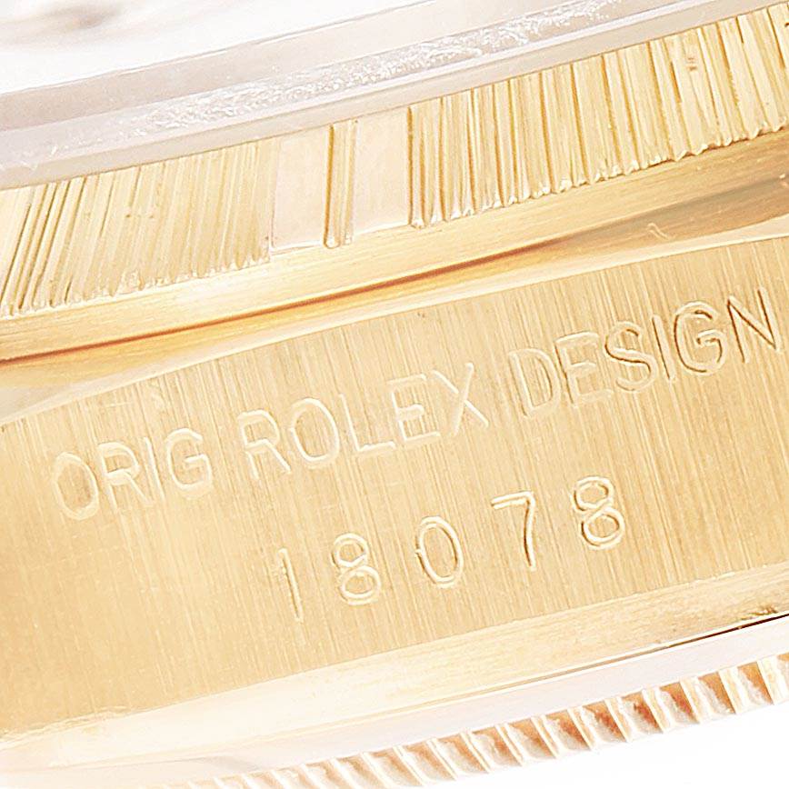 The image shows a close-up of the engraved details on the case of a Rolex President 18078 Men
s Yellow Gold Champagne Dial 18078 Men
s Yellow Gold Champagne Dial model watch.