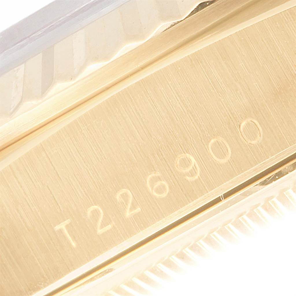 This close-up image of the Rolex President 18238 Men
s Yellow Gold Champagne Dial 18238 Men
s Yellow Gold Champagne Dial model showcases the serial number engraved on the watch case.