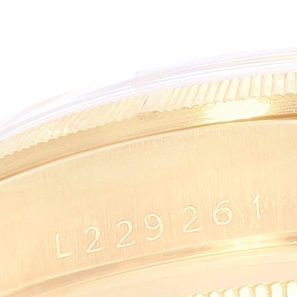 The image shows a close-up of the engraved serial number and fluted bezel edge on the side of a Rolex President 18248 Men's Yellow Gold Champagne Dial 18248 Men's Yellow Gold Champagne Dial watch.