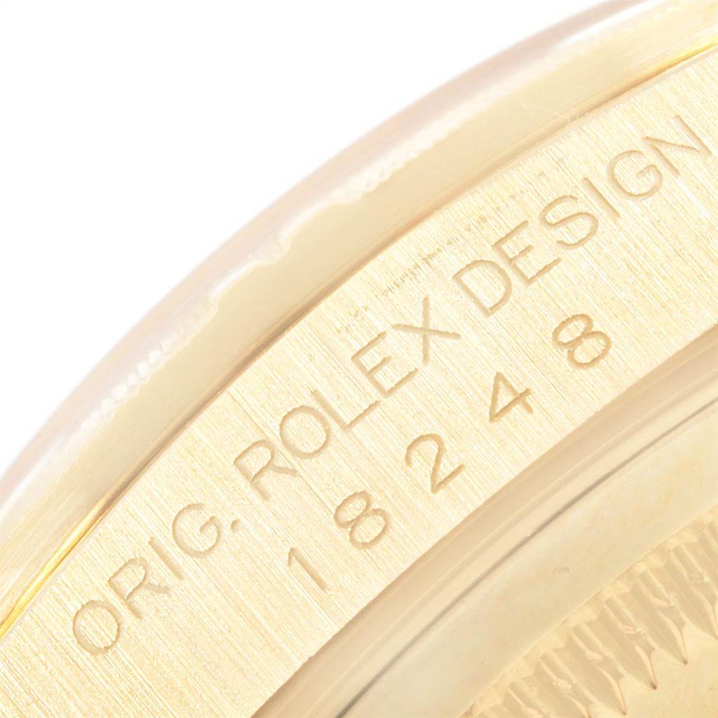This close-up image shows the engraved bezel of a Rolex President 18248 Men's Yellow Gold Champagne Dial 18248 Men's Yellow Gold Champagne Dial model watch with the design number 18248.