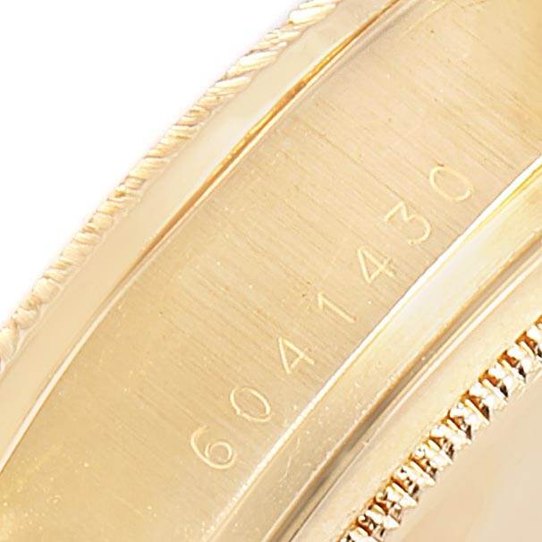 This close-up image shows the serial number engraved on the gold case of a Rolex President 18038 Men
s Yellow Gold Black Dial 18038 Men
s Yellow Gold Black Dial model watch.