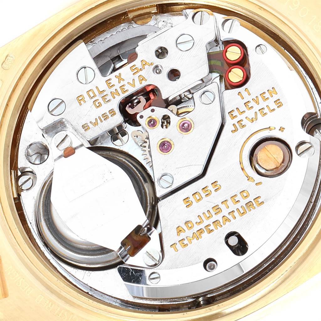 The image shows the inner mechanism of a Rolex President 19018 Men's Yellow Gold Champagne Dial 19018 Men's Yellow Gold Champagne Dial watch, highlighting its movement parts and detailed engravings.