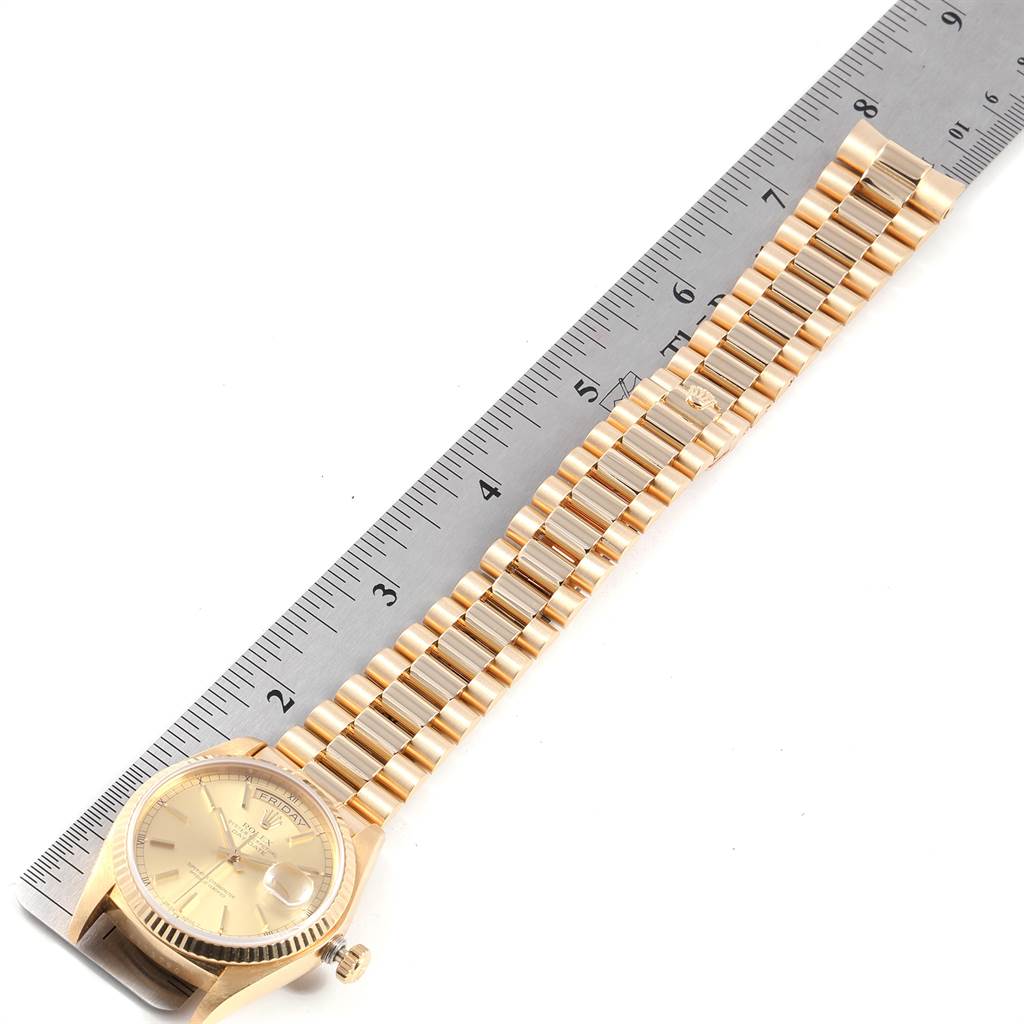 The image shows the face and bracelet of a Rolex President 18038 Men
s Yellow Gold Champagne Dial 18038 Men
s Yellow Gold Champagne Dial model watch, with a ruler for scale.