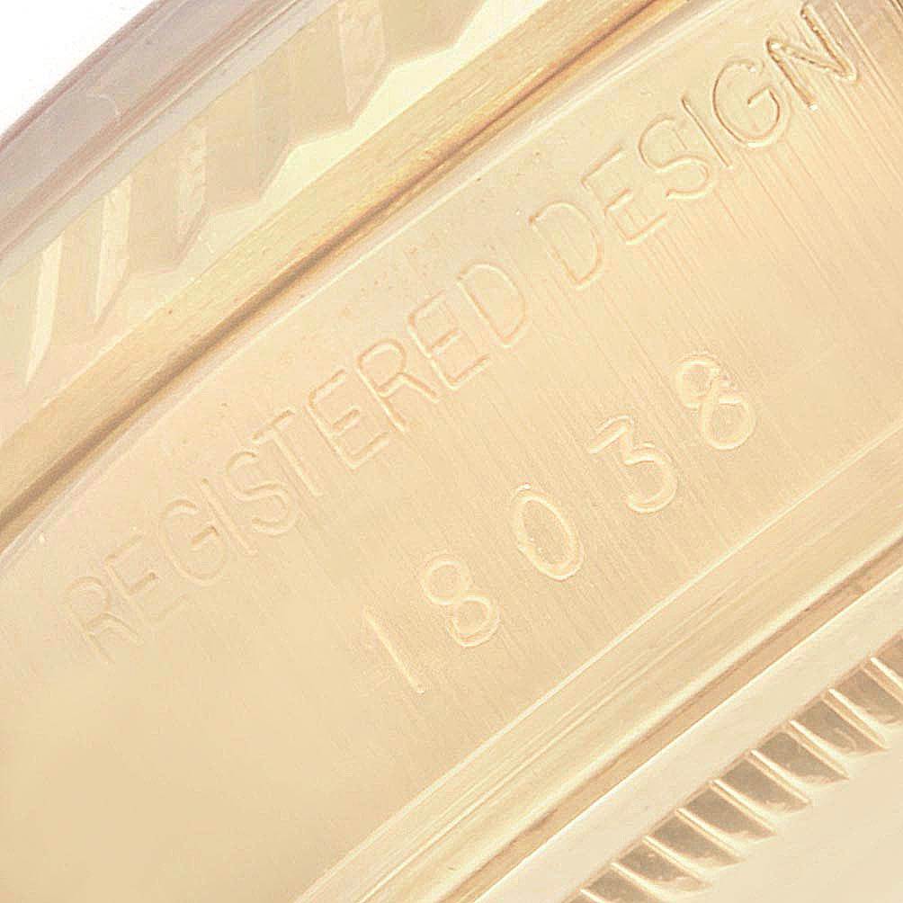 This close-up image shows the "REGISTERED DESIGN 18038" engraving on the gold case of a Rolex President 18038 Men
s Yellow Gold Champagne Dial 18038 Men
s Yellow Gold Champagne Dial model watch.