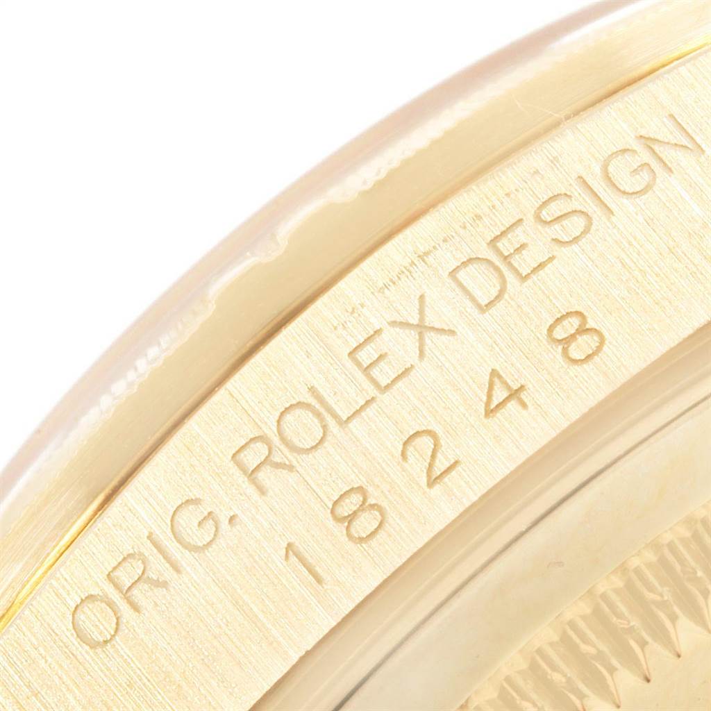 The image shows an angled close-up of the side of the Rolex President 18248 Men's Yellow Gold Champagne Dial 18248 Men's Yellow Gold Champagne Dial model, highlighting the engraved bezel.