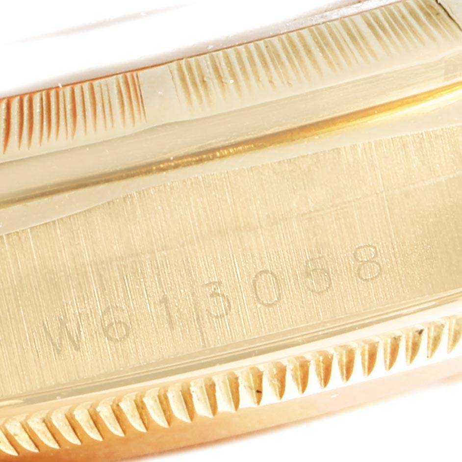This image shows a partial close-up of the case with a serial number on a Rolex President 18248 Men's Yellow Gold Champagne Dial 18248 Men's Yellow Gold Champagne Dial model watch.