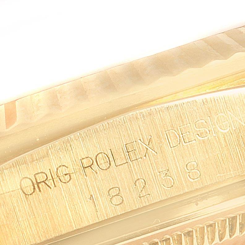This close-up image shows the engraved model details on the case side of a Rolex President 18238 Men
s Yellow Gold Champagne Dial 18238 Men
s Yellow Gold Champagne Dial watch.