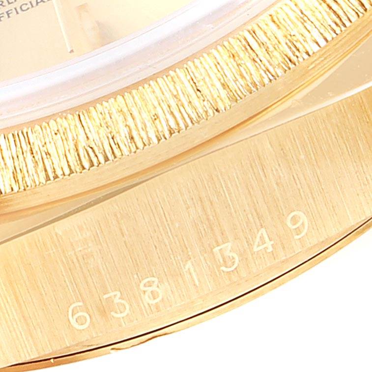 The image shows a close-up of the bezel and part of the serial number on a Rolex President 18078 Men
s Yellow Gold Champagne Dial 18078 Men
s Yellow Gold Champagne Dial model watch.