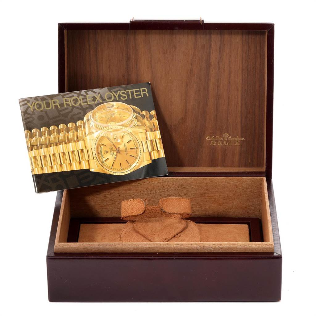 The image shows an open Rolex President 18078 Men
s Yellow Gold Champagne Dial 18078 Men
s Yellow Gold Champagne Dial watch box with a booklet featuring the watch.