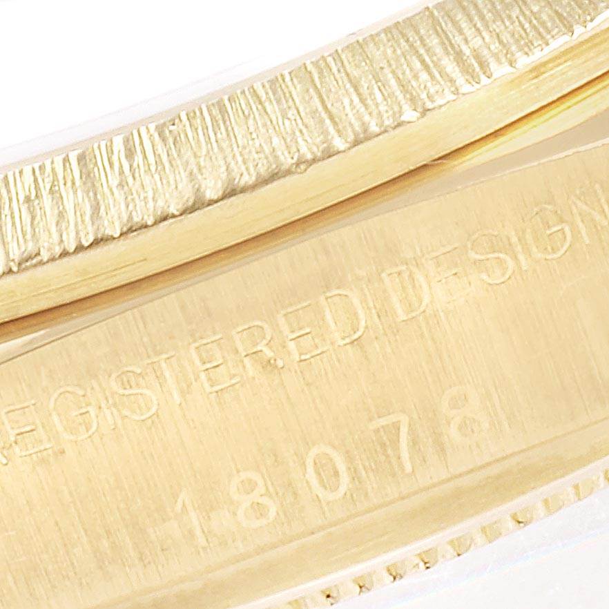 Close-up of the side of a Rolex President 18078 Men
s Yellow Gold Blue Dial 18078 Men
s Yellow Gold Blue Dial watch, showing the engraved "REGISTERED DESIGN" and model number "18078".