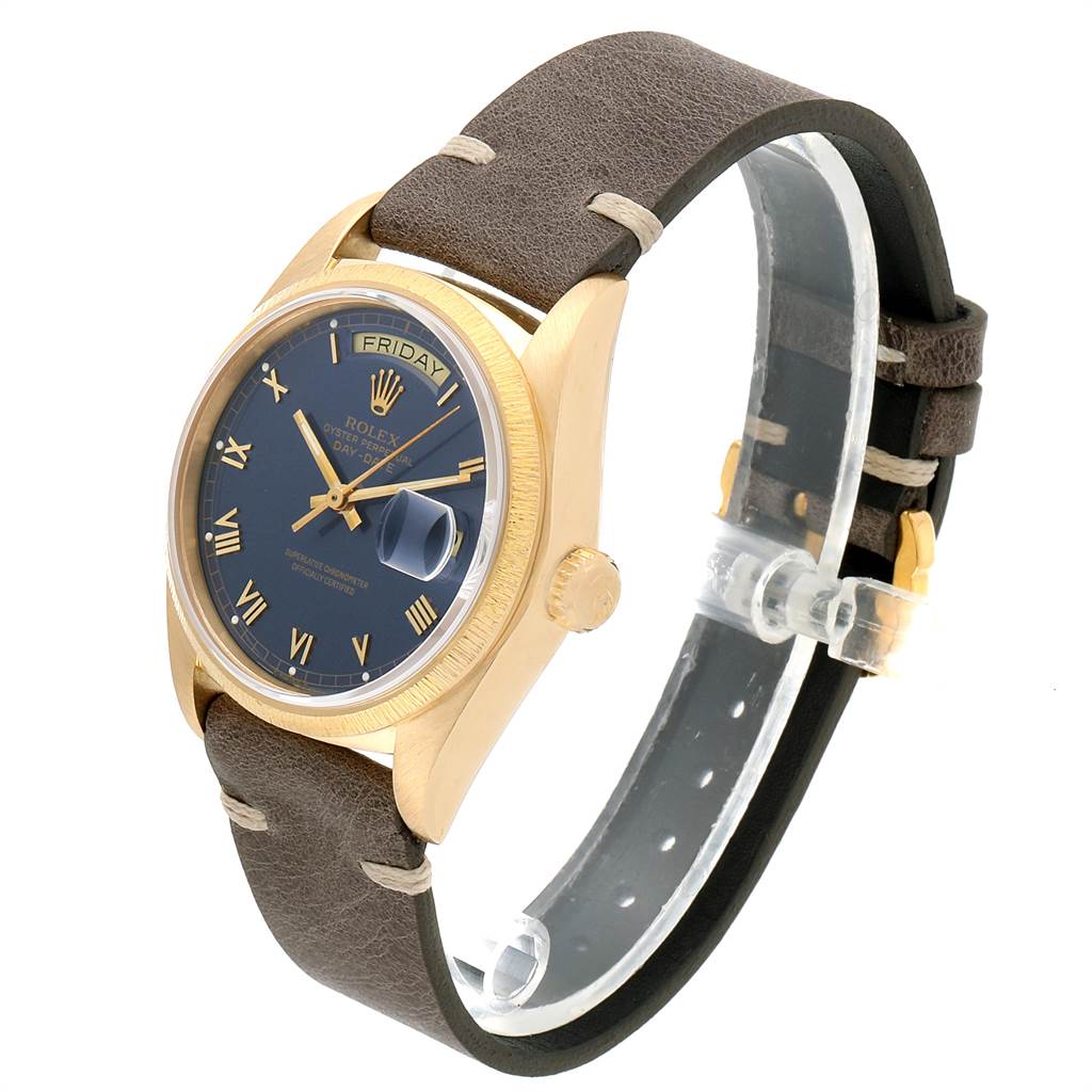 The image shows a side-angle view of the Rolex President 18078 Men
s Yellow Gold Blue Dial 18078 Men
s Yellow Gold Blue Dial model watch, highlighting the face, crown, and leather strap.