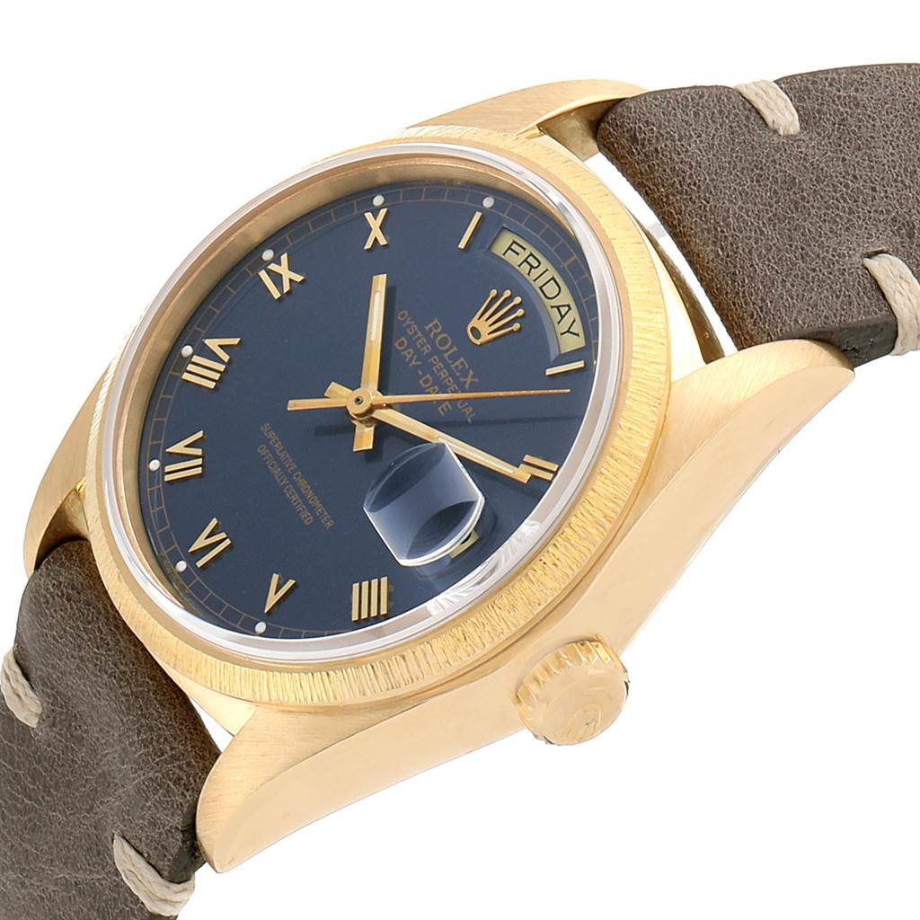 This Rolex President 18078 Men
s Yellow Gold Blue Dial 18078 Men
s Yellow Gold Blue Dial model watch is shown at an angle displaying the face, crown, day and date indicators, and a leather strap.