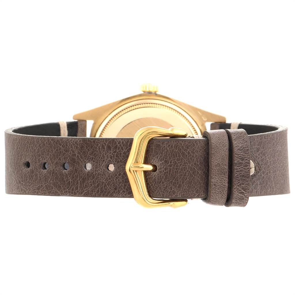 This image shows the back of a Rolex President 18078 Men
s Yellow Gold Blue Dial 18078 Men
s Yellow Gold Blue Dial model watch with its brown leather strap and gold buckle.