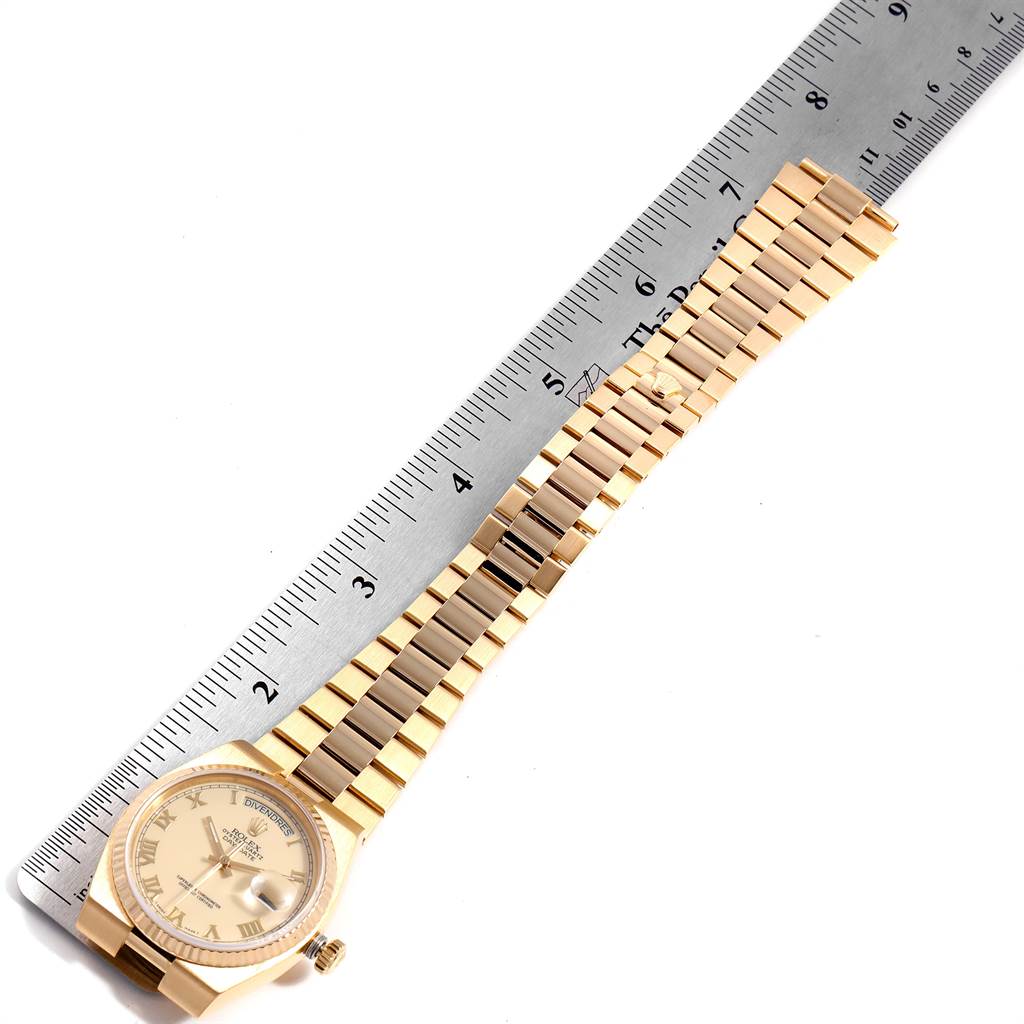 The image shows a full view of the Rolex President 19018 Men
s Yellow Gold Beige Dial 19018 Men
s Yellow Gold Beige Dial model watch, positioned next to a ruler for scale.