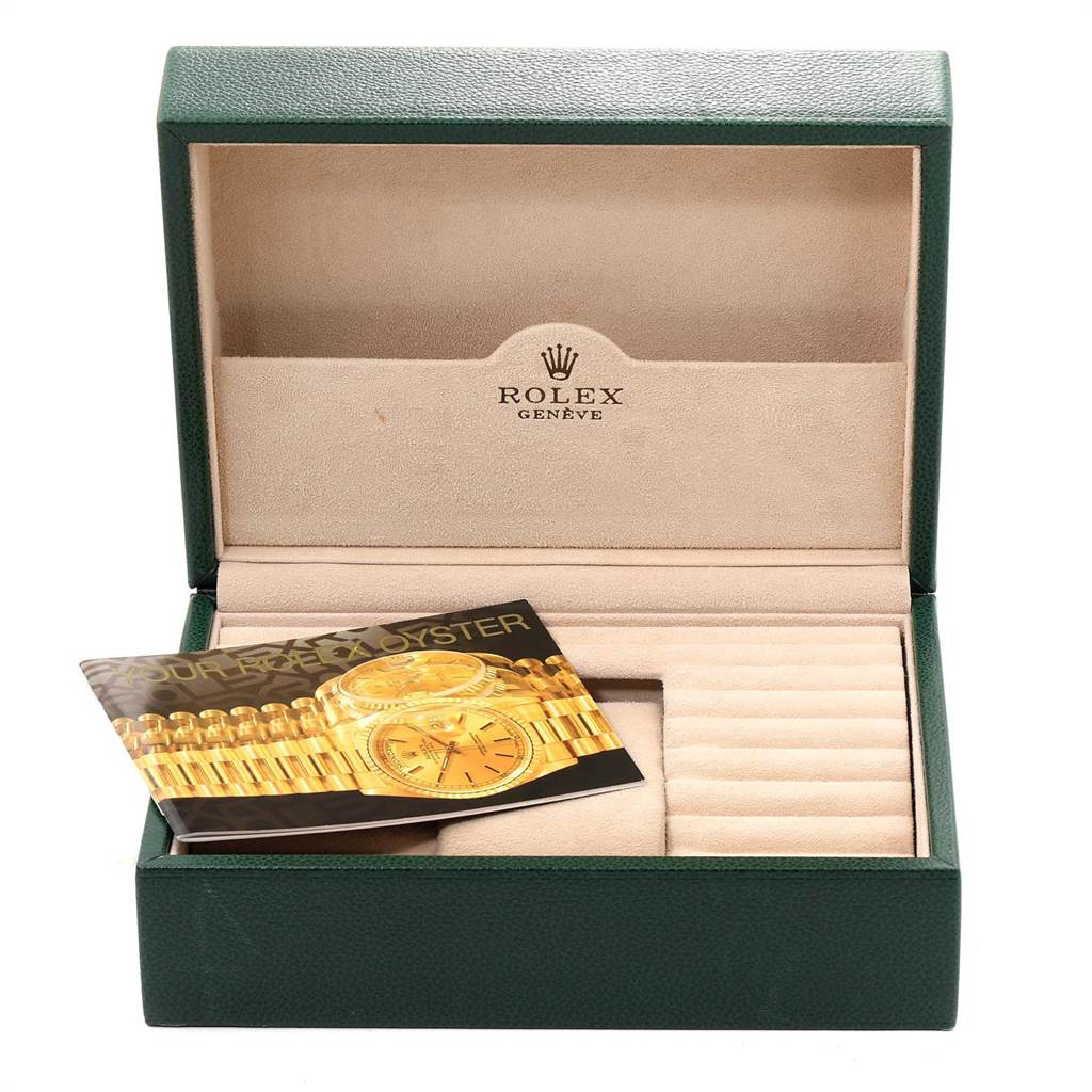 This image shows the opened packaging box of a Rolex President 19018 Men
s Yellow Gold Beige Dial 19018 Men
s Yellow Gold Beige Dial model watch with a booklet inside.