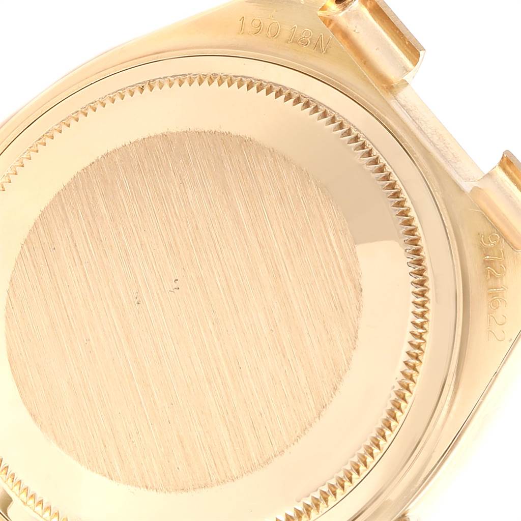 This image shows the back casing of a Rolex President 19018 Men
s Yellow Gold Beige Dial 19018 Men
s Yellow Gold Beige Dial model watch, focusing on the engravings and casing details.