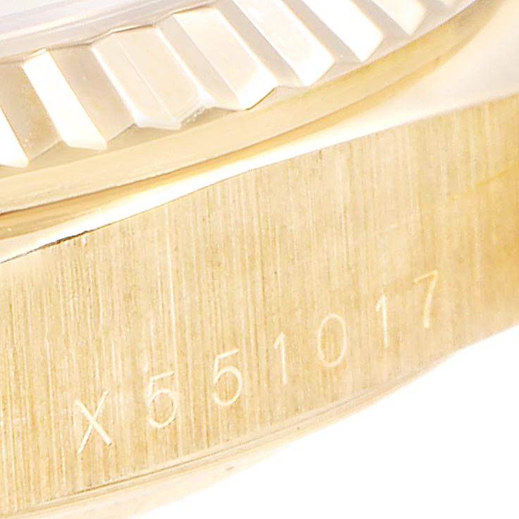 This close-up image shows the fluted bezel and serial number on the side case of the Rolex President 18238 Men
s Yellow Gold Champagne Dial 18238 Men
s Yellow Gold Champagne Dial model watch.