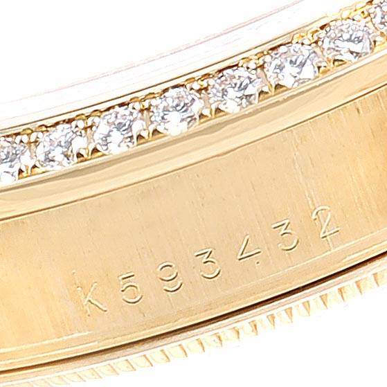 Close-up of the serial number and diamond-studded bezel on a Rolex President 118388 Men's Yellow Gold Mother of Pearl Dial 118388 Men's Yellow Gold Mother of Pearl Dial model watch.