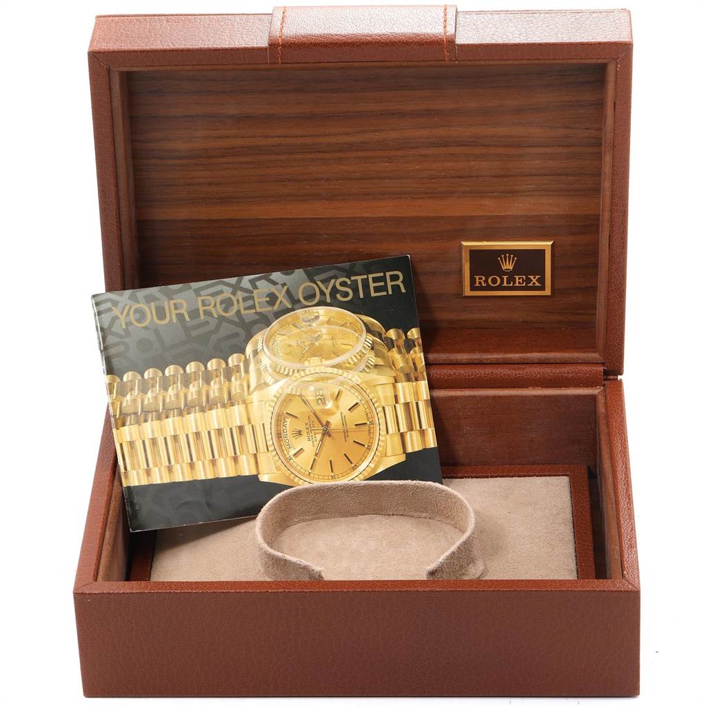 The image shows an open Rolex President 18038 Men
s Yellow Gold Champagne Dial 18038 Men
s Yellow Gold Champagne Dial watch box, with an instruction booklet and padded cushion inside.