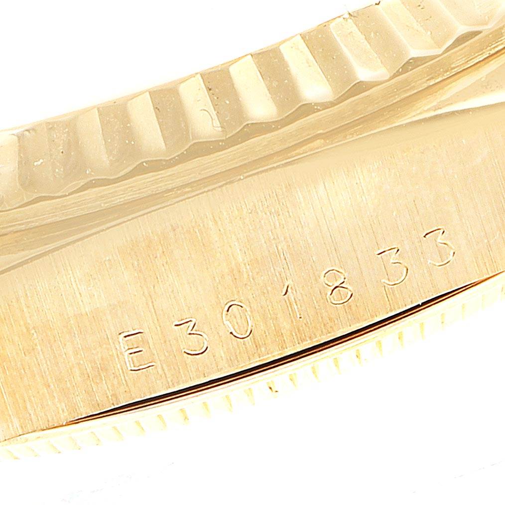 This image shows a close-up of the serial number and the fluted bezel of a Rolex President 18238 Men's Yellow Gold Champagne Dial 18238 Men's Yellow Gold Champagne Dial model watch.
