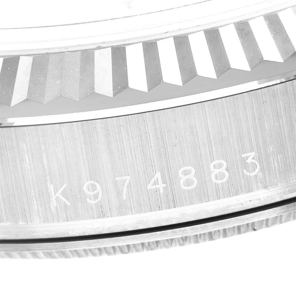 Shown is a close-up of the serial number and fluted bezel of the Rolex President 118239 Men's White Gold Brown Dial 118239 Men's White Gold Brown Dial model watch.