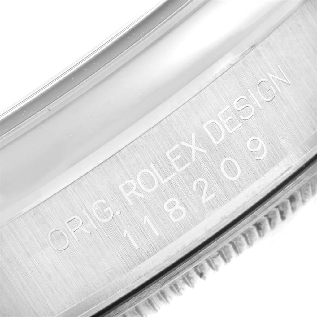 This image shows a close-up of the side engraving on a Rolex President 118209 Men
s White Gold White Dial 118209 Men
s White Gold White Dial watch, displaying the model number.