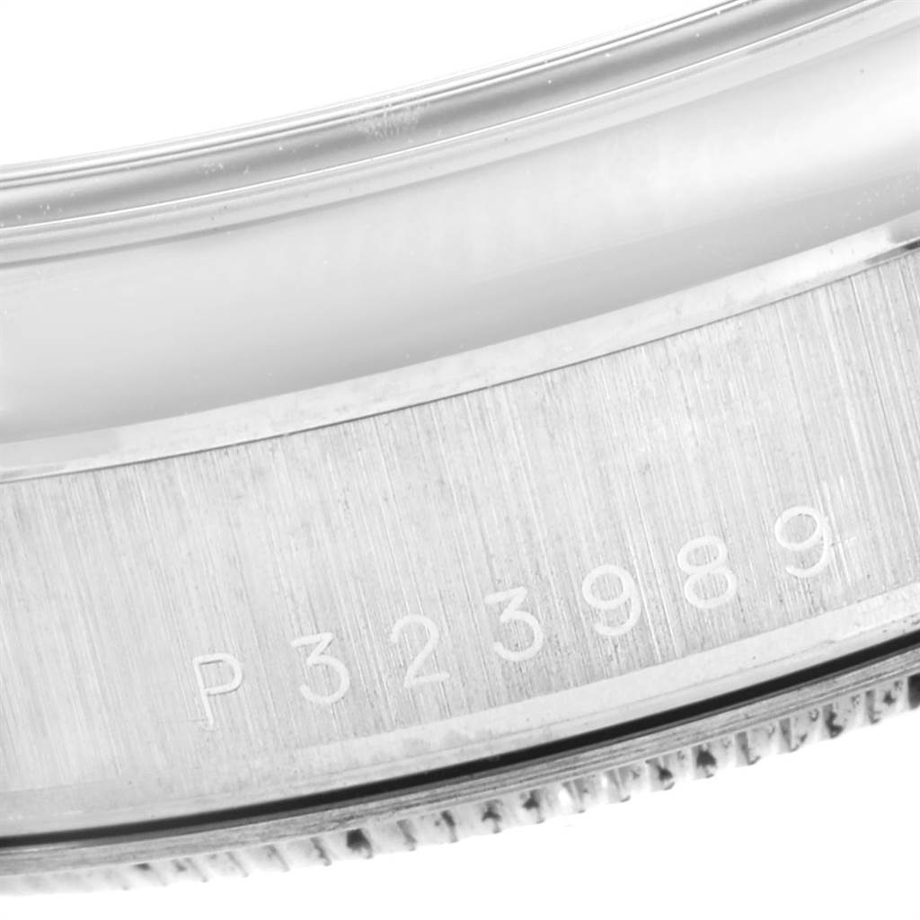 The image shows a close-up of the serial number engraved on the case of a Rolex President 118209 Men
s White Gold White Dial 118209 Men
s White Gold White Dial model watch.
