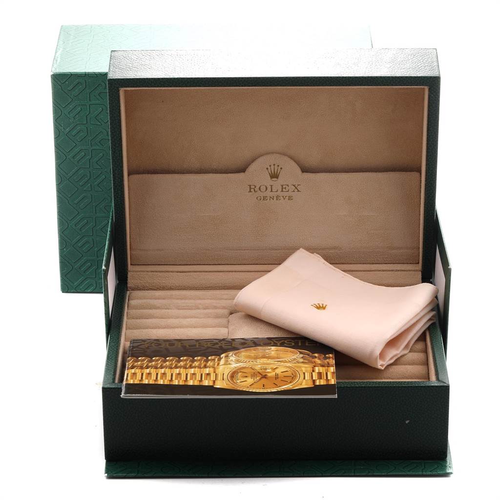 The image shows an open Rolex President 18238 Men
s Yellow Gold Mother of Pearl Dial 18238 Men
s Yellow Gold Mother of Pearl Dial model watch box at an angle revealing a cleaning cloth and a booklet inside.