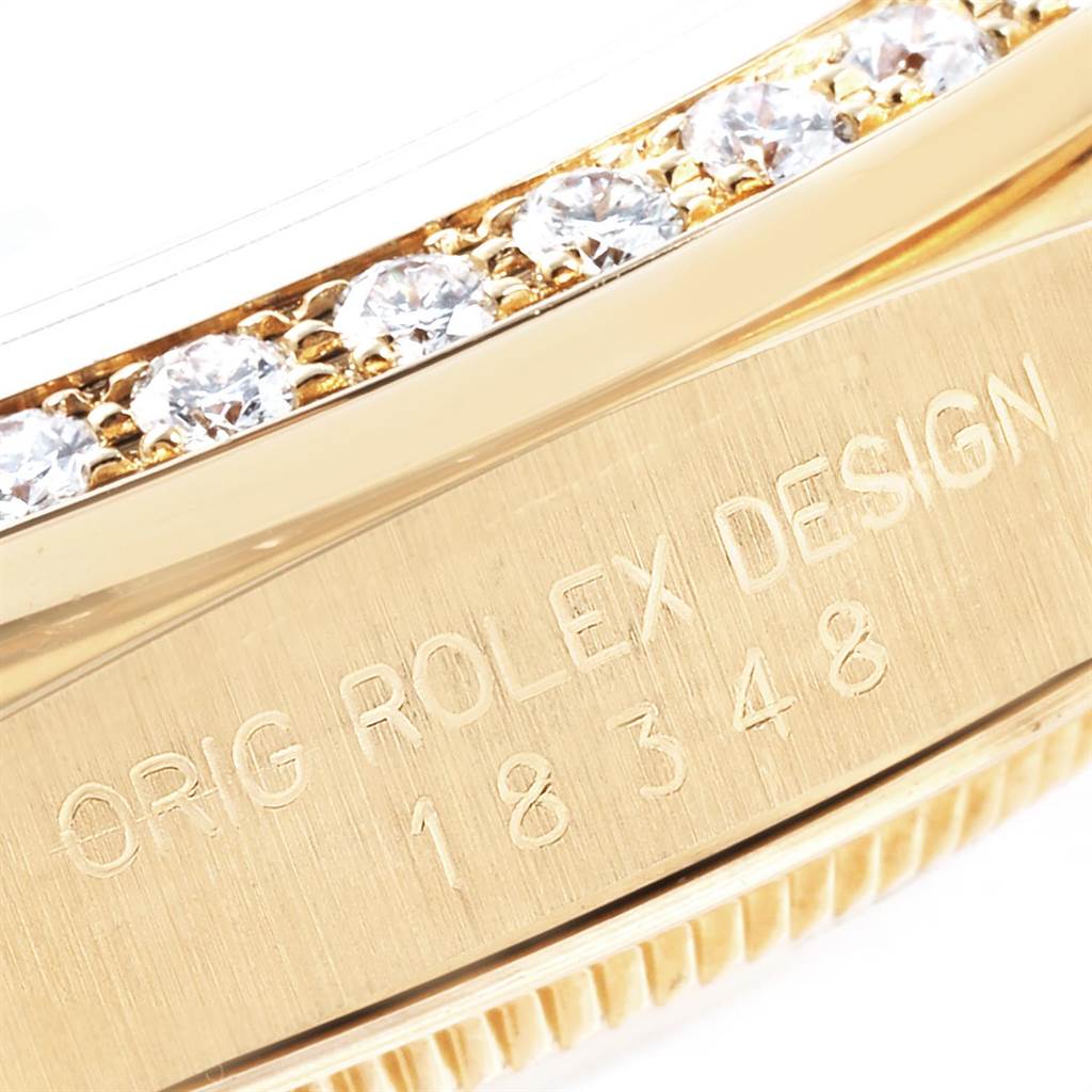 This close-up image shows the engraved side and diamond-studded bezel of a Rolex President 18238 Men
s Yellow Gold Mother of Pearl Dial 18238 Men
s Yellow Gold Mother of Pearl Dial model watch.