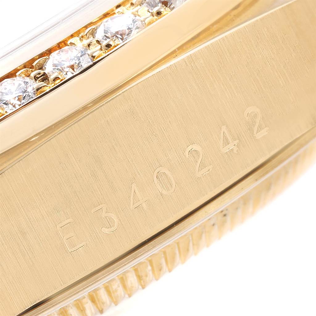 The image shows a close-up of the side and bezel of a Rolex President 18238 Men
s Yellow Gold Mother of Pearl Dial 18238 Men
s Yellow Gold Mother of Pearl Dial watch, featuring engraved serial numbers and diamond decorations.