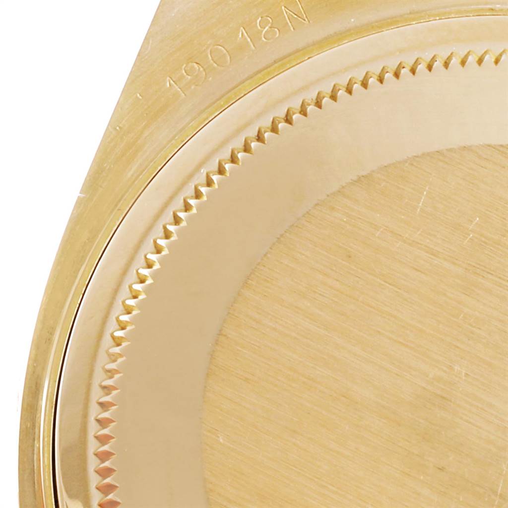 This image shows a close-up of the case back and part of the edge of a Rolex President 19018 Men
s Yellow Gold Champagne Dial 19018 Men
s Yellow Gold Champagne Dial watch model.