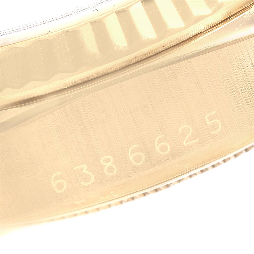 This close-up image shows the engraved serial number on the gold case of a Rolex President 18038 Men's Yellow Gold Blue Dial 18038 Men's Yellow Gold Blue Dial watch.