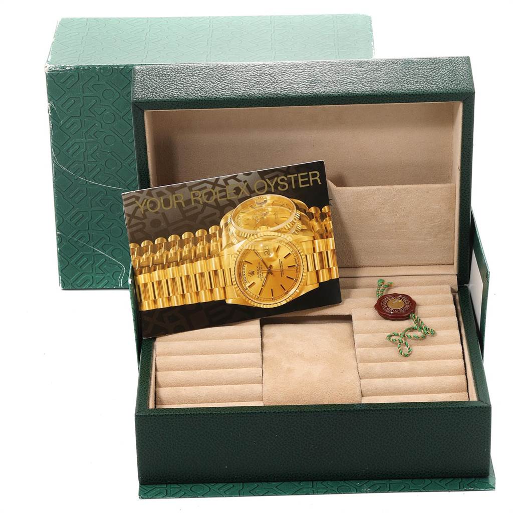 The image shows a Rolex President 18238 Men
s Yellow Gold Champagne Dial 18238 Men
s Yellow Gold Champagne Dial model watch box and accessories at an angle displaying the interior compartments and promotional card.