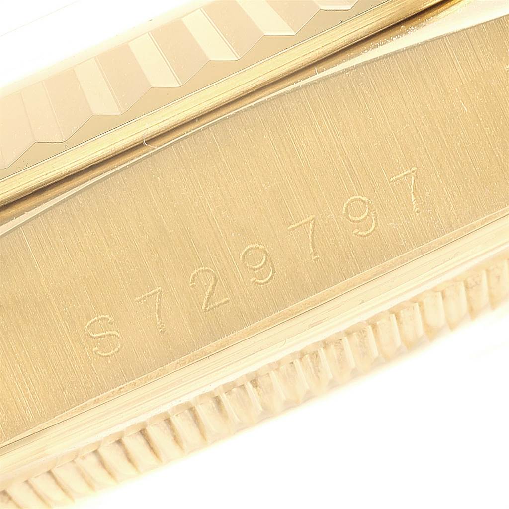 Close-up of the side of a Rolex President 18238 Men
s Yellow Gold Champagne Dial 18238 Men
s Yellow Gold Champagne Dial watch showing the serial number engraved on its gold surface.
