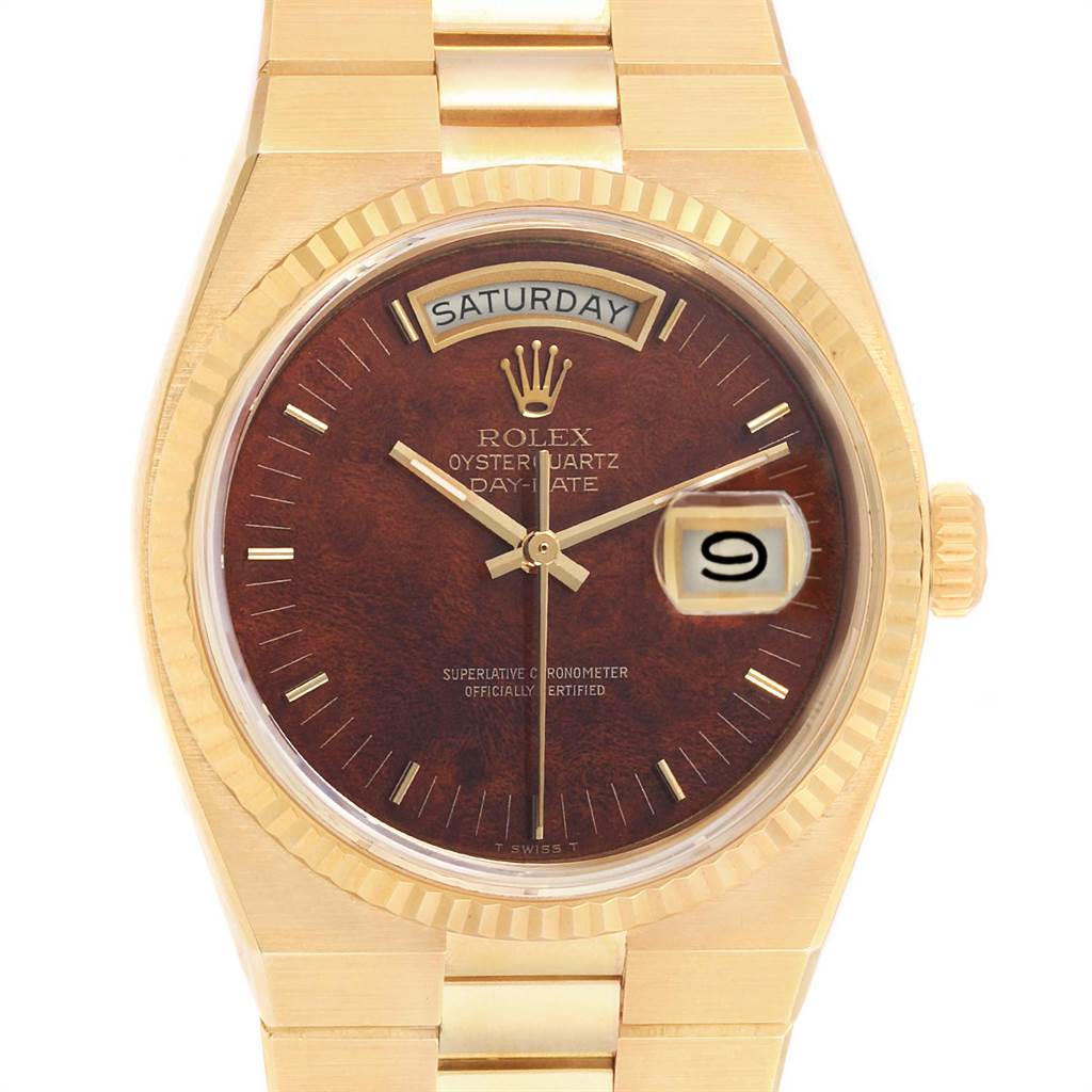 The Rolex President 14418 Men
s Yellow Gold Brown Dial 14418 Men
s Yellow Gold Brown Dial Oysterquartz Day-Date watch is shown from a frontal angle, displaying the dial, day, and date.