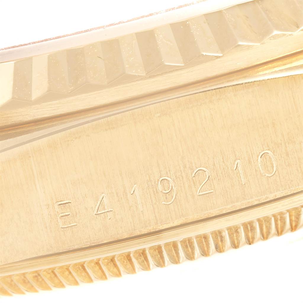 Close-up of the Rolex President 18238 Men
s Yellow Gold Champagne Dial 18238 Men
s Yellow Gold Champagne Dial model showing the edge of the bezel and part of the case with the serial number.