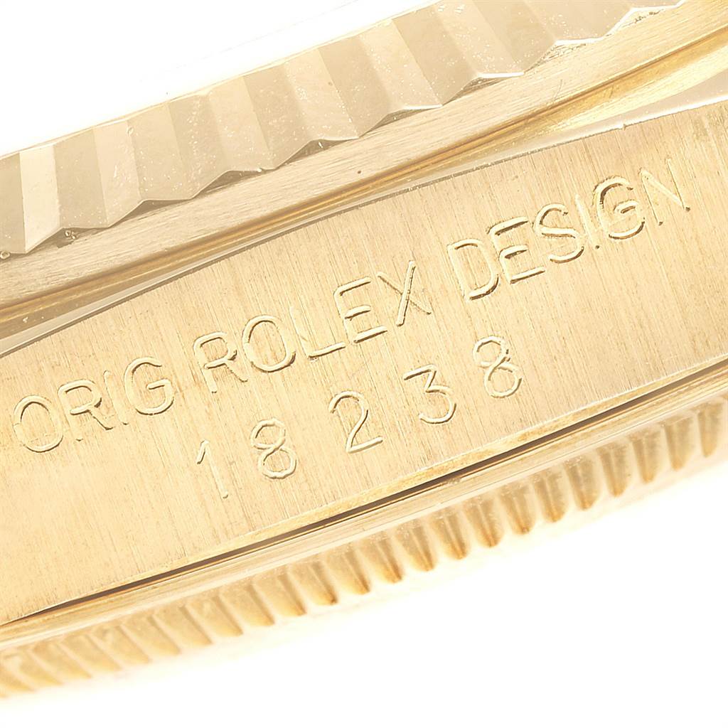 This image shows a close-up angled view of the engravings on the side of a Rolex President 18238 Men
s Yellow Gold Champagne Dial 18238 Men
s Yellow Gold Champagne Dial model watch, displaying "ORIG ROLEX DESIGN 18238."