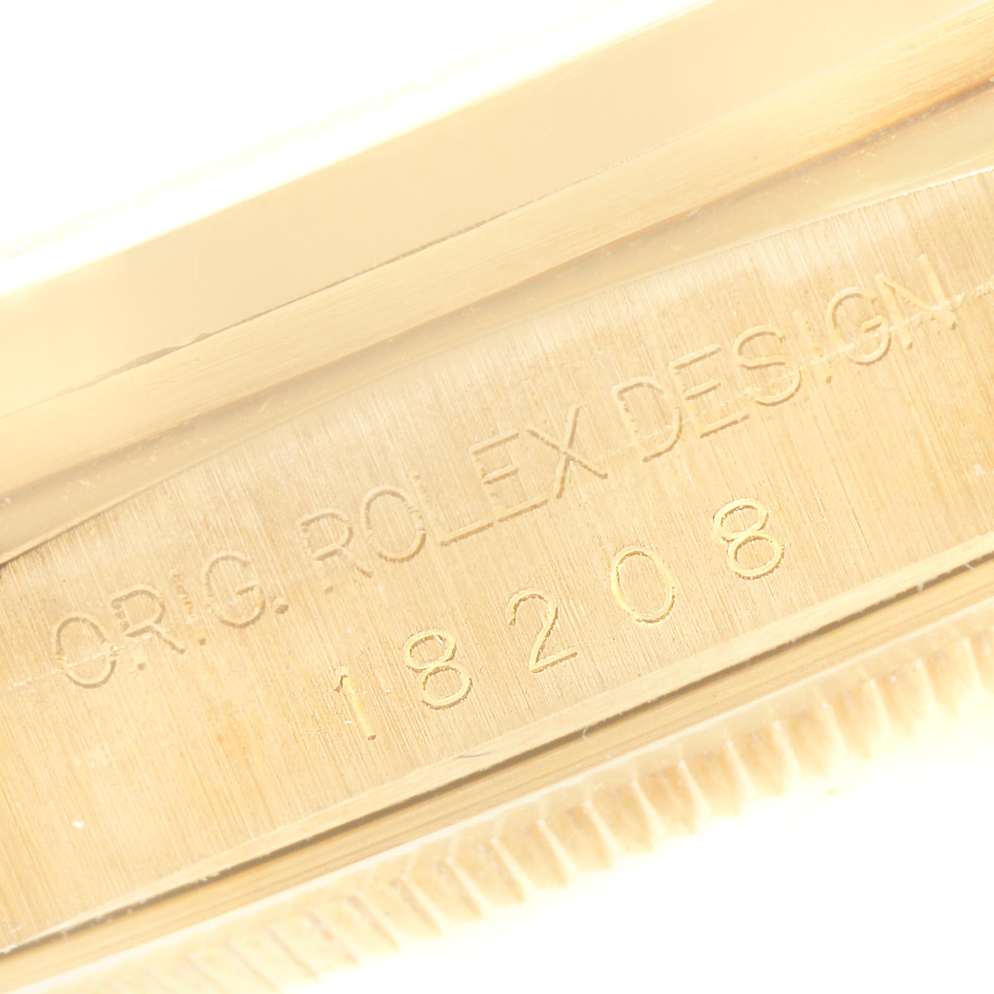 This image shows a close-up of the side view of a Rolex President 18208 Men's Yellow Gold Blue Dial 18208 Men's Yellow Gold Blue Dial model watch, focusing on the engraved model number and design details.