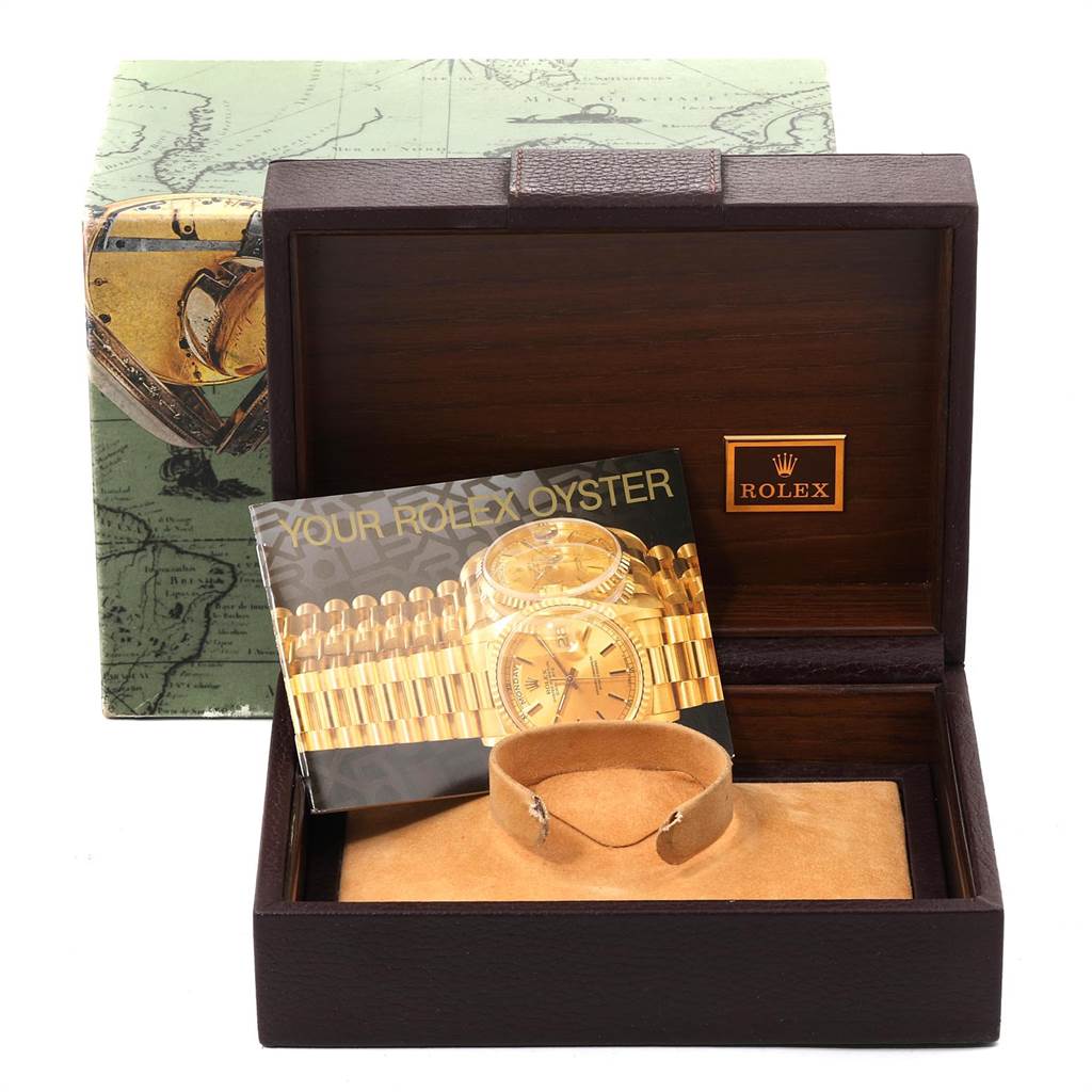 The image shows a Rolex President 18238 Men
s Yellow Gold Champagne Dial 18238 Men
s Yellow Gold Champagne Dial watch box, an inner cushion, and a booklet, viewed from the front.