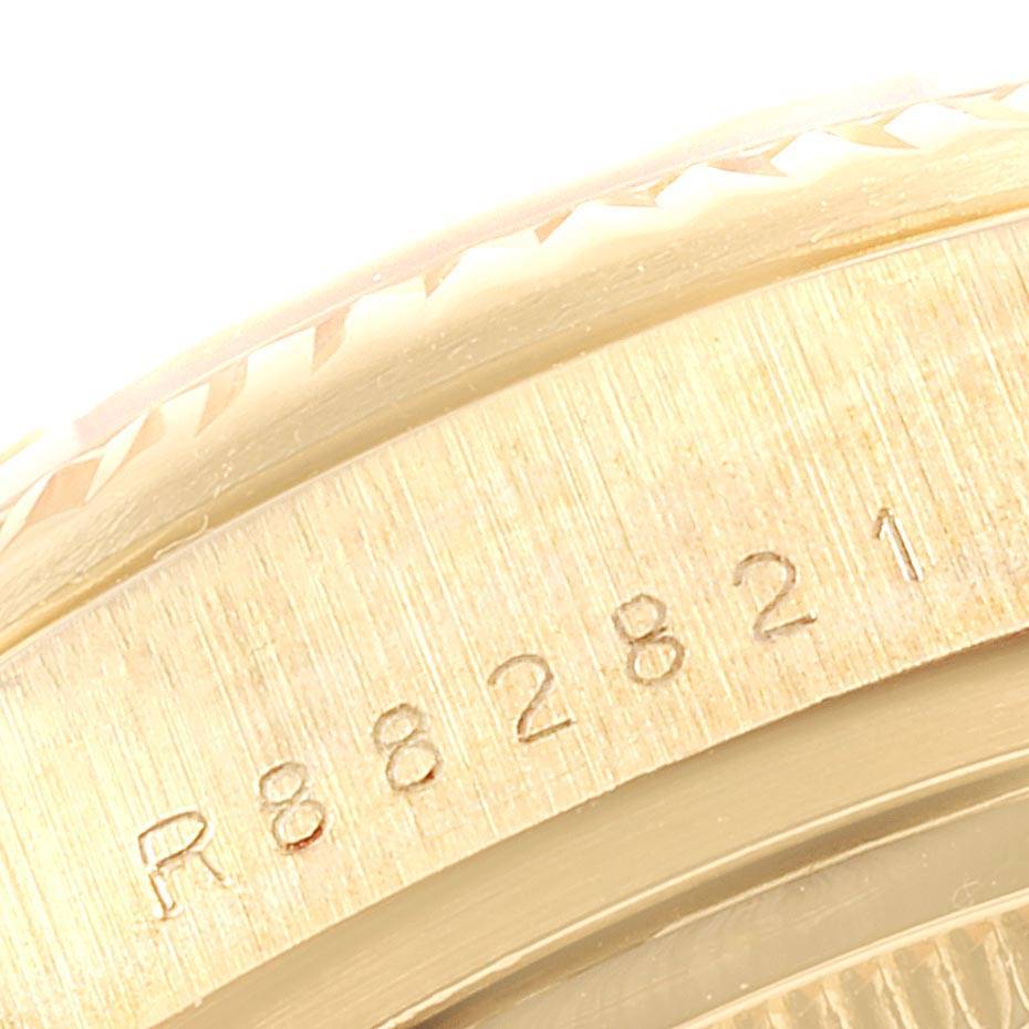 This close-up image shows part of the bezel, case, and serial number of a Rolex President 18038 Men's Yellow Gold Champagne Dial 18038 Men's Yellow Gold Champagne Dial watch.