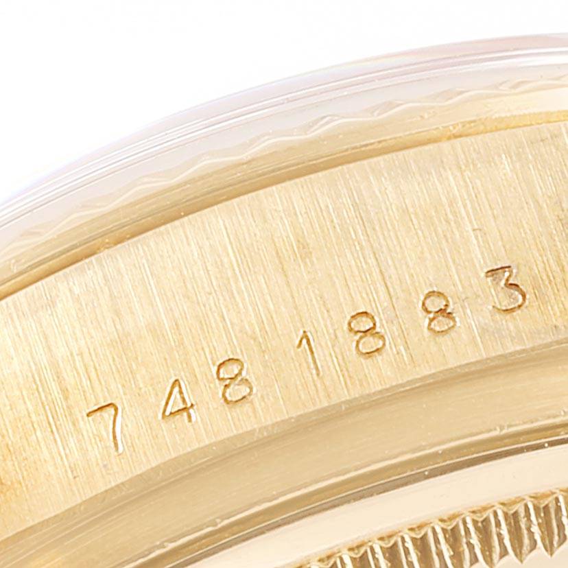 The image shows a close-up of the serial number engraved on the gold case edge of a Rolex President 18038 Men
s Yellow Gold Champagne Dial 18038 Men
s Yellow Gold Champagne Dial model watch.