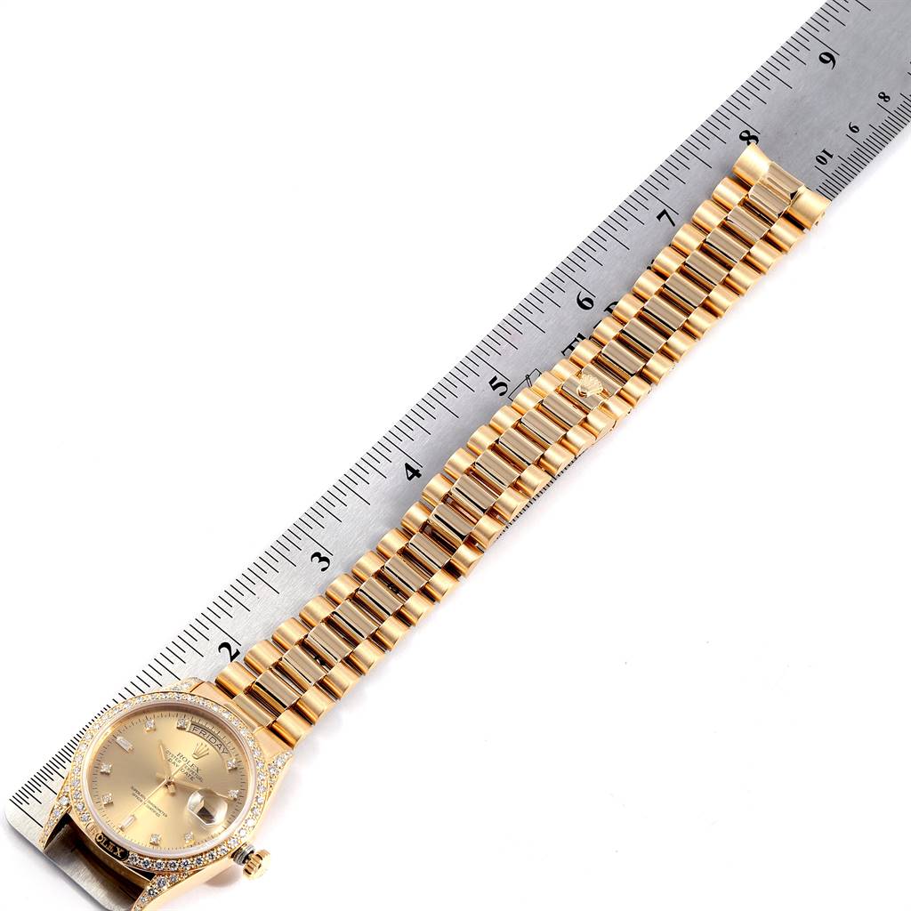 The angle shows the entire President model Rolex watch, including a detailed view of the dial, bracelet, and clasp, next to a ruler for scale.