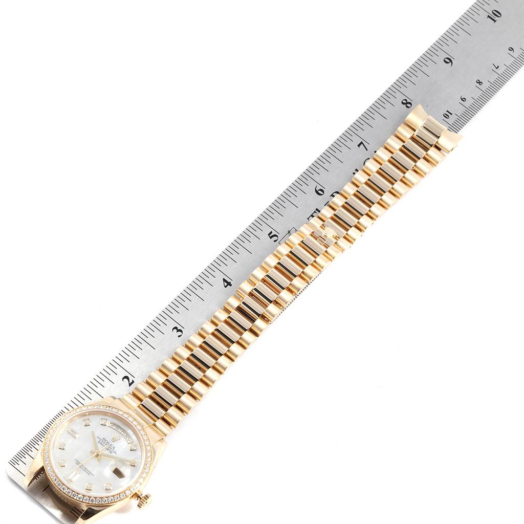 The image shows a Rolex President 118348 Men
s Yellow Gold Mother of Pearl Dial 118348 Men
s Yellow Gold Mother of Pearl Dial model watch laid flat with a metal ruler adjacent for measurement.