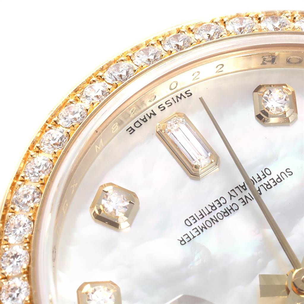 This close-up image of a Rolex President 118348 Men
s Yellow Gold Mother of Pearl Dial 118348 Men
s Yellow Gold Mother of Pearl Dial model watch highlights the diamond bezel, markers, and partial dial with text.